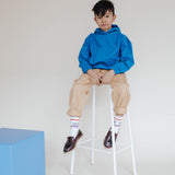 Repose AMS Kids Chino Pants in Sand, shown worn with rolled cuffs. Only the chino pants are for sale.