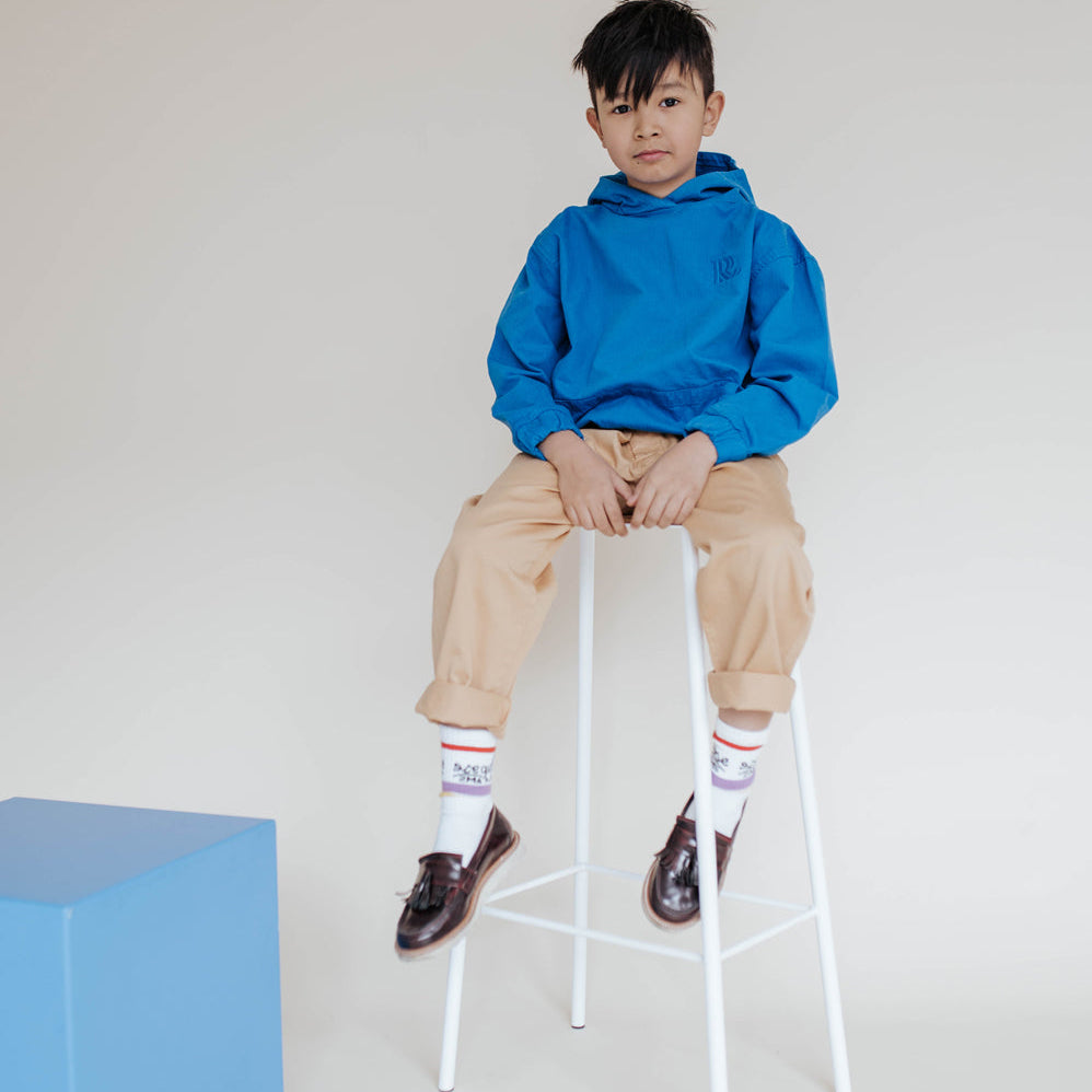 Repose AMS Kids Chino Pants in Sand, shown worn with rolled cuffs. Only the chino pants are for sale.