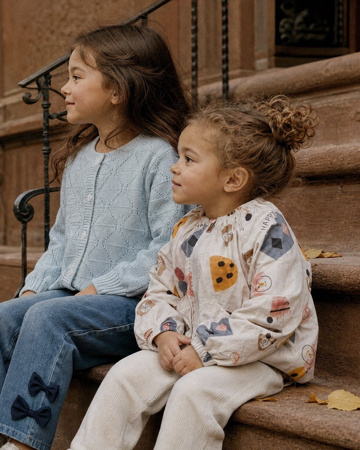 Two girls on a Brooklyn stoop in autumn, mobile crop