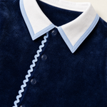 Bebe Sweeny navy velour babygrow, collar with light blue edging and ric-rac trim close-up