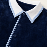 Bebe Sweeny navy velour babygrow, collar with light blue edging and ric-rac trim close-up