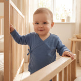 Baby wearing the steel blue wrapover top